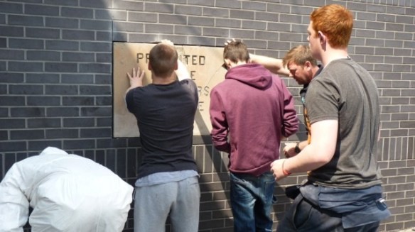 Putting the plaque in place Photo - Tony Pate